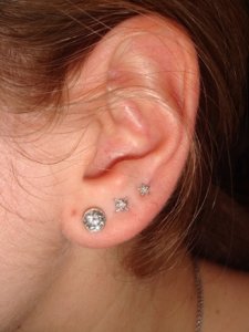 one piercing in their ear 