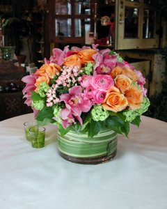 orchid centerpiece w wrapped greens in vase.jpg