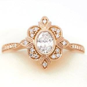 oval-diamond-rose-gold-engagement-ring-with-accent-diamonds-and-milgrain.jpg