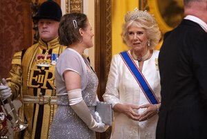 22124304-7781543-Meanwhile_the_Duchess_of_Cornwall_smiled_while_she_spoke_with_an-a-31_1576102...jpg