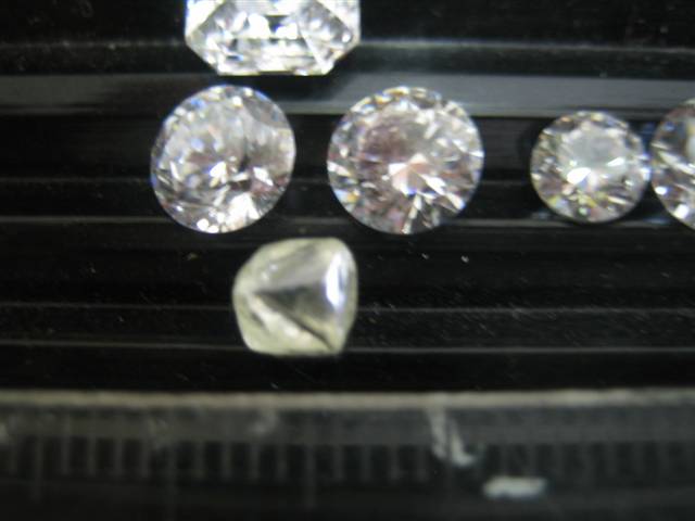 1.31ct distorted Octahedra beside 6.5mm CZ's