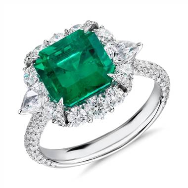 For inspiration: emerald-cut emerald and diamond pear-shaped halo ring set in 18K white gold at Blue Nile