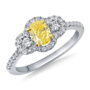 A Fancy Intense Yellow Oval Cut Diamond Halo Ring crafted in 18K two-tone Gold.