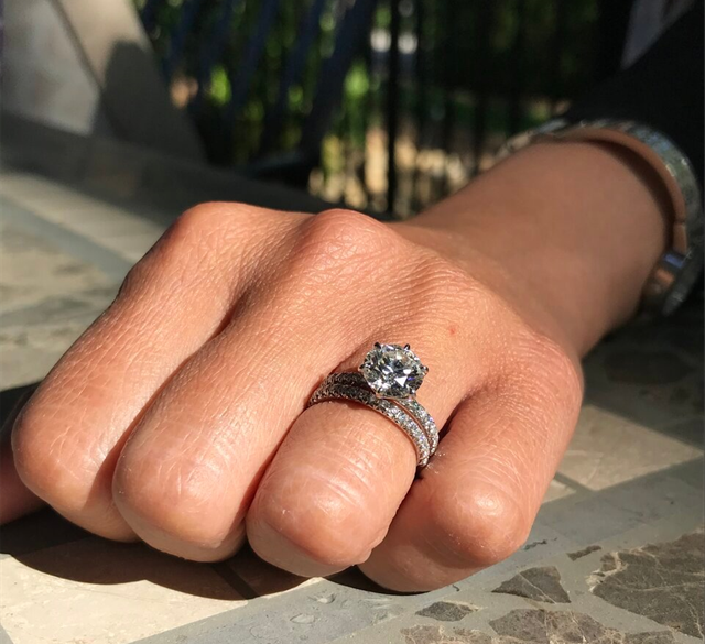 a hand with a beautiful diamond engagement ring