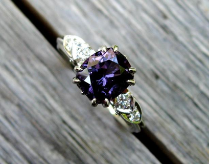 purple ring with white side diamonds in a wooden deck seam