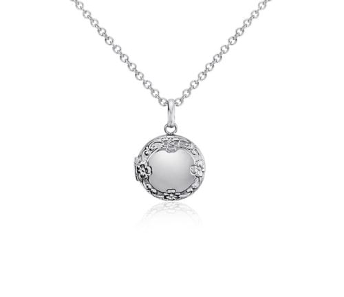 a small silver locket on a delicate chain