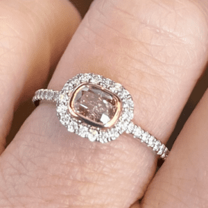Pink diamond ring in white diamond halo.