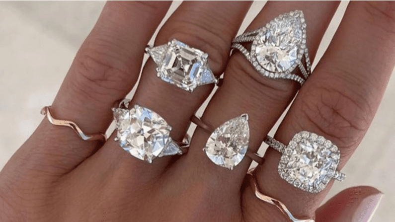 Different Diamond Shapes on engagement rings worn on multiple fingers